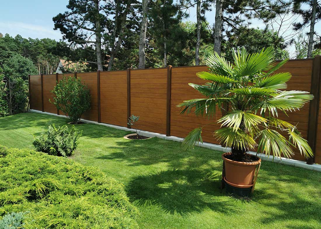 Dichtzaun Kunststoff in täuschend echter Holzoptik im Garten