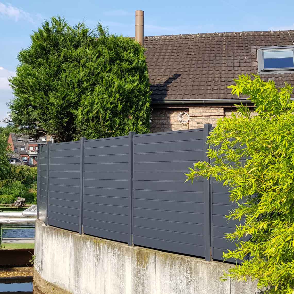 Sichtschutzwand in Anthrazit aus Kunststoff PVC im Garten auf Mauer